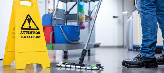 Worker janitor Mopping Floor In Office with trolley